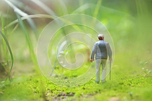 Surreal image of mysterious man walking alone in field