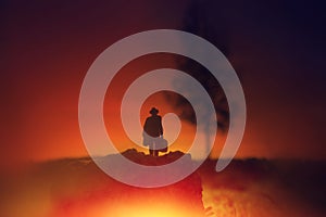 Surreal image of mysterious man walking alone in field during sunset