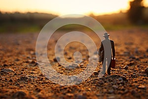Surreal image of mysterious man walking alone during sunset