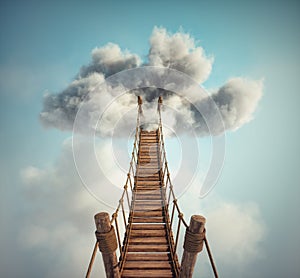 Surreal image of a rope bridge to a cloud. The concept of adventure or getaway
