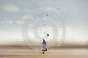 Surreal image of a young woman dreaming with a balloon