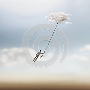 Surreal moment of a man who is dragged into the sky by a cloud photo