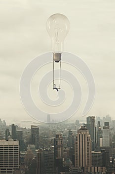 Surreal moment of a woman traveling on a swing carried by a light bulb over a metropolis