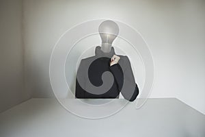 Surreal person with a light bulb affixed to the head, concept of idea, innovation, business, creativity, energy photo