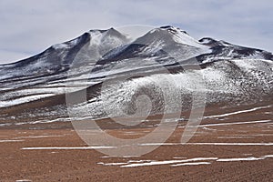 Surreal winter landscapes and snow capped mountain scenery in the SIloli Desert, Sud Lipez province, Bolivia