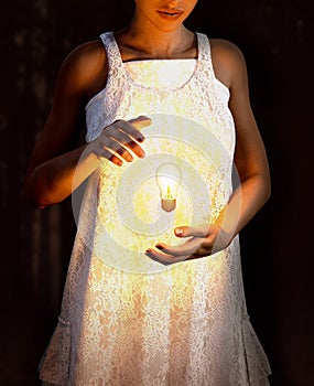 Surreal Woman levitating bright lightbulb