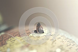 Surreal woman looks at a destination for her journey in a giant globe