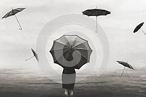 Surreal woman with umbrella in the rain with flying black umbrellas around