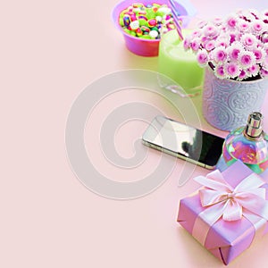 Surrealism Composition flat lay gift to a woman Modern gadget mobile phone glass cocktail perfume bouquet of flowers Preparing for