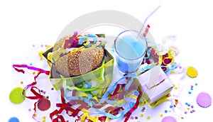 Surrealism Festive composition drinks snacks holiday hamburger cookie tinsel confetti gift box cocktail saturated colors.