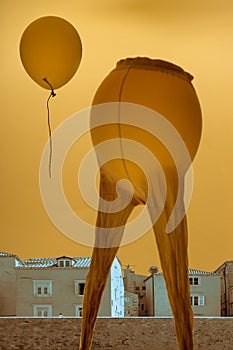 Surrealist composition `Parting`, a collage of the city landscape, balloon and women`s tights