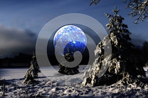 Surrela moon over cold winter landscape