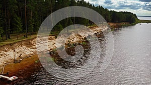 Surrendering Shore, Pines Adrift, Reservoir Surge Under Cumulus Patchwork. Aerial Drone Shot.