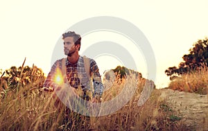 Surrounded by nature. a handsome young man enjoying the view while hiking.