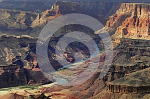 Surrounding the Colorado River, the Grand Canyon takes on an orange hue under the setting sun.