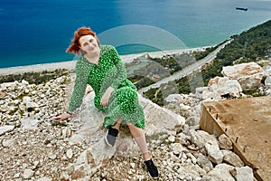 Surroundings of Antalya in spring, view of Mediterranean Sea from observation deck. Young woman in green evening dress