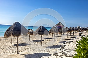 Surveillance of beach watchmen in the caribbean with lines of umbrellas. Sea watchtower and bathers on a caribbean. photo