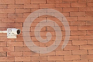 Surveillance cameras are a modern technology to prevent thieves and thieves that are installed on red brick construction as a wall