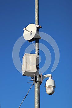 Surveillance system with an orange warning light located on a pole in the open. The threat of privacy and the protection of