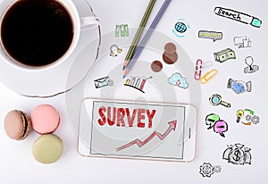 Survey, Business Concept. Mobile phone and coffee cup on a white office desk