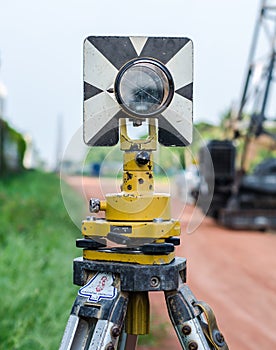 Survey instrument set on a tripod in the field