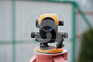 Surveying measuring equipment level transit on tripod at construction building area site