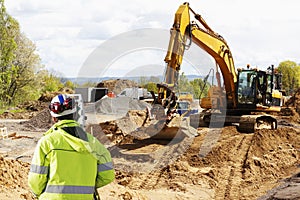 Surveyor, bulldozer and excavation works