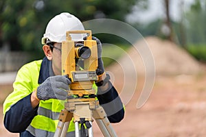 Surveyor Civil Engineer using equipment theodolite or total positioning station on the construction site