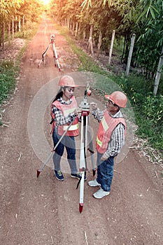 Surveyor or Engineer making measure by Theodolite in a field.