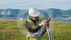 Surveyor engineer is measuring level on construction site. Geodesist ensure precise measurements before undertaking