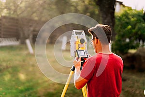 surveyor engineer measuring and working with total station