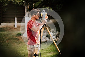 Surveyor engineer working with total station theodolite and gps system on construction site