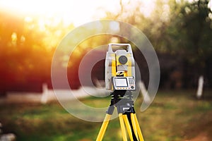 Surveyor engineering equipment with theodolite and total station in a garden