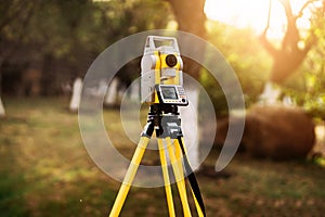 Surveyor engineering equipment with theodolite and total station in a garden