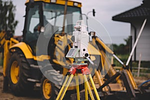 Surveyor equipment - theodolite total positioning system outdoors at construction site