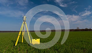 Surveyor equipment on a tripod in the field
