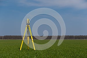Surveyor equipment on a tripod in the field