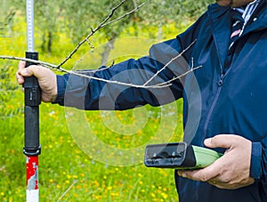 Surveyor with GPS kit at a country roadside.