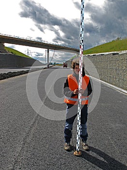 Surveyor with levelling staff photo