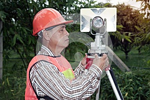 Surveyor making setting prism reflector on the field.