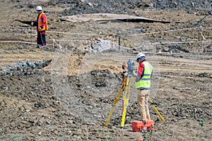 The surveyor is shooting at a building site