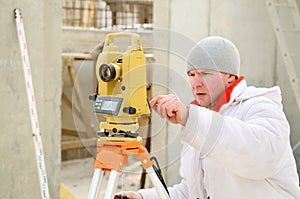 Surveyor worker at construction