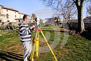 Surveyor worker making measurement in the garden, total station