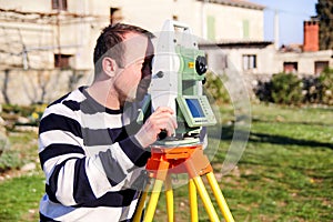 Surveyor worker making measurement in the garden, total station