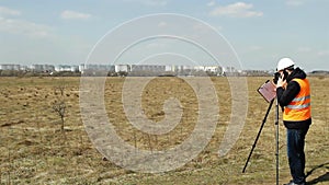 Surveyor worker measures the distance and length using measuring equipment for the construction of a new micro district