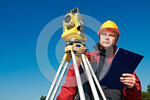 surveyor worker with theodolite over bright sky