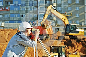 Surveyor working with theodolite equipment