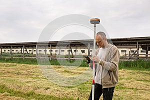 A surveyor works with a GNSS receiver