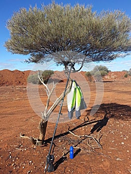Surveyors GPS drink bottle and Jacket in a tree outback Australia