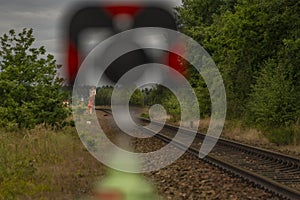 Surveyors with instruments on railway track near green forest in south Bohemia